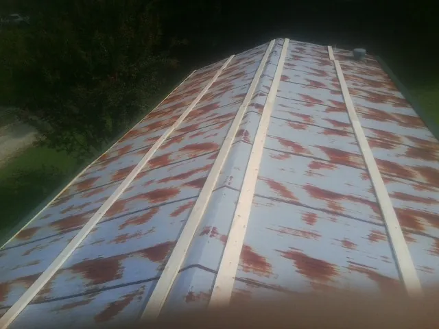 Rusted metal roof panels with new wood purlins before replacement — Storm Damage Roof Repair in Imnaha by Roofing Brothers
